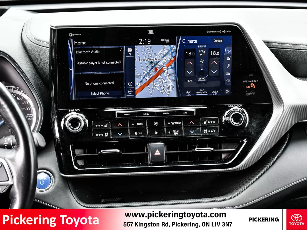 Close-up view of the infotainment system and climate controls of a red 2022 Toyota Highlander Hybrid Limited AWD SUV taken at Pickering Toyota dealers