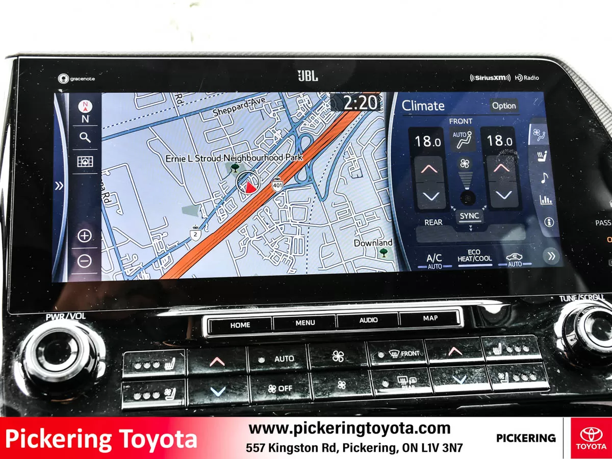 Infotainment system display in a Toyota vehicle shows Bluetooth audio, climate control, and navigation map features of a red 2022 Toyota Highlander Hy